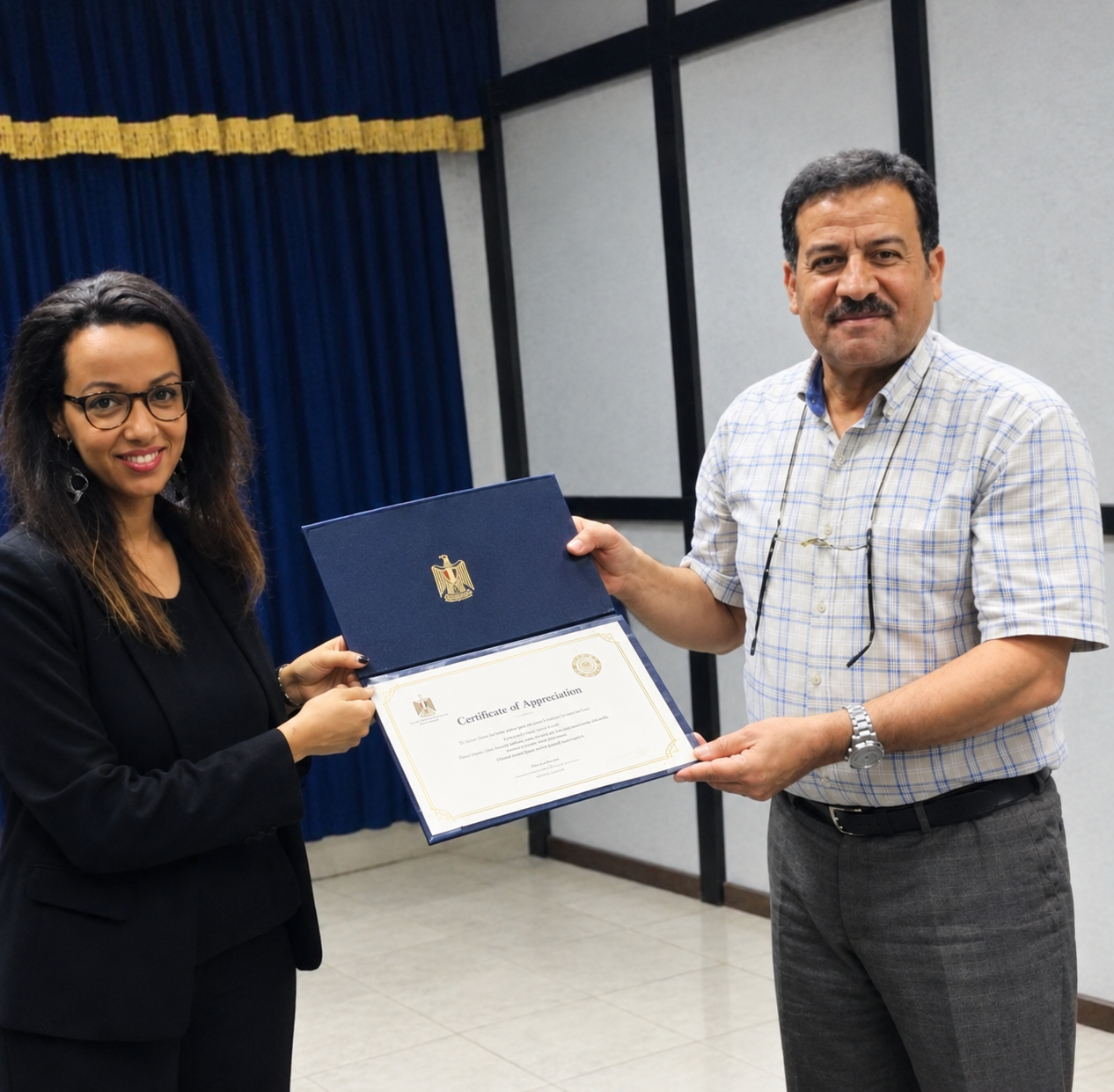 Receiving a certificate of appreciation from Lieutenant General Mohammed Fadhil Al-Shimmary, Chief of Staff, National Operations Centre, Office of the Prime Minister of Iraq.